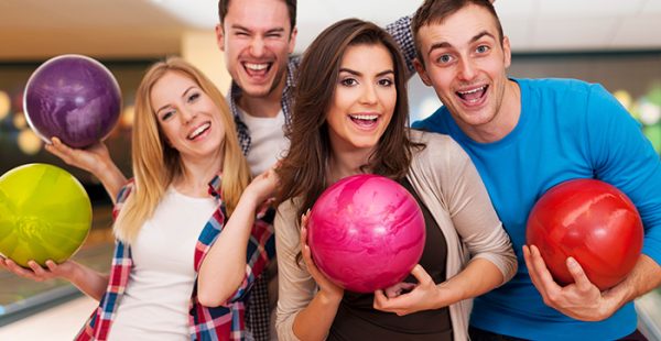 Happy friends bowling together